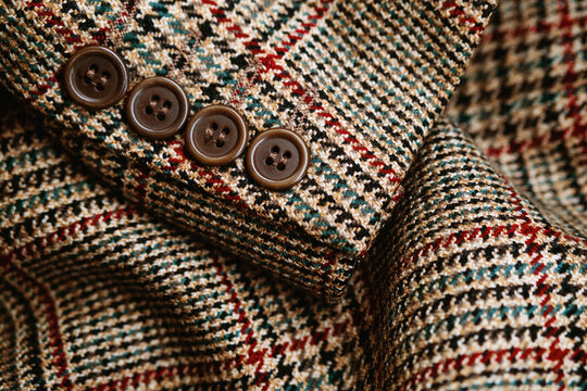 Close up of tweed jacket with glen check pattern and buttons