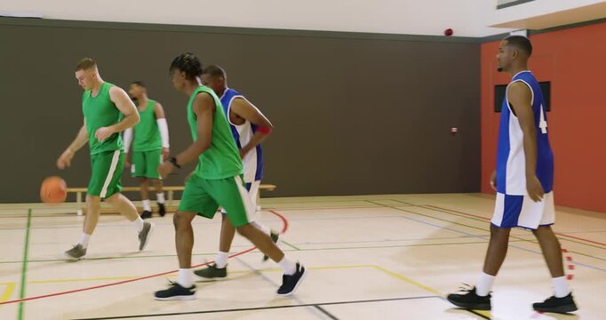 After collision green player securing ball on court, dribbling toward baseline and advancing play