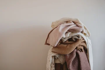 Soft Textured Wool Sweaters In A Neutral Palette Stacked For Winter Organization © Floral Deco