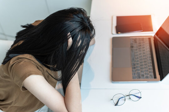 Anxiety disorder, panic attack working woman, stressful depressed student or businesswoman, burnout person with mental health illness, headache and migraine, sitting in front of laptop computer desk
