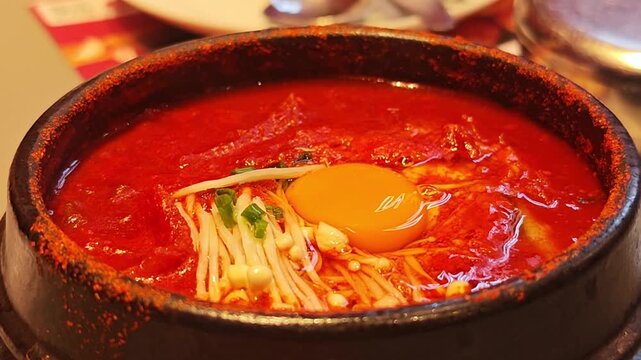 Kimchi soup with egg in a hot pot.