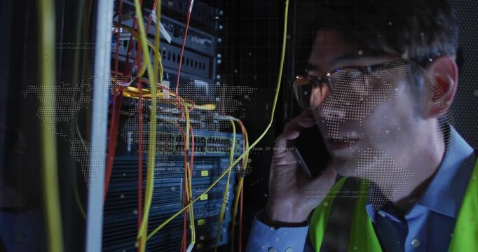 Tech taking phone call, leaning into rack, checking network cables, dotted world-map guiding fix