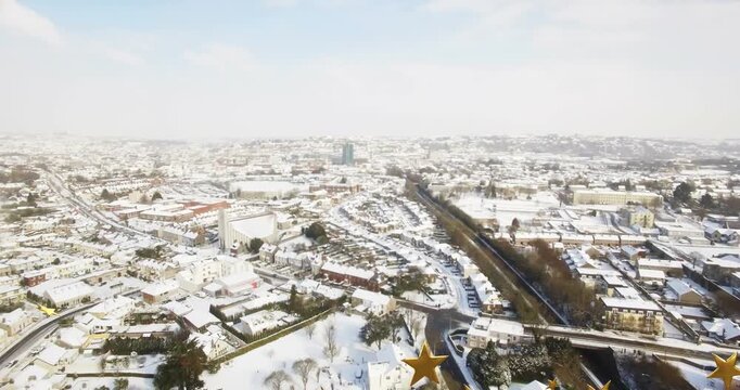 Camera tilting over snowy town, gold stars and bell grouping, drifting, fading for marketing