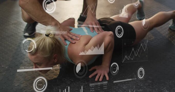 Vertical video: Coach touching back woman doing pushups on gym floor HUD guiding posture correction