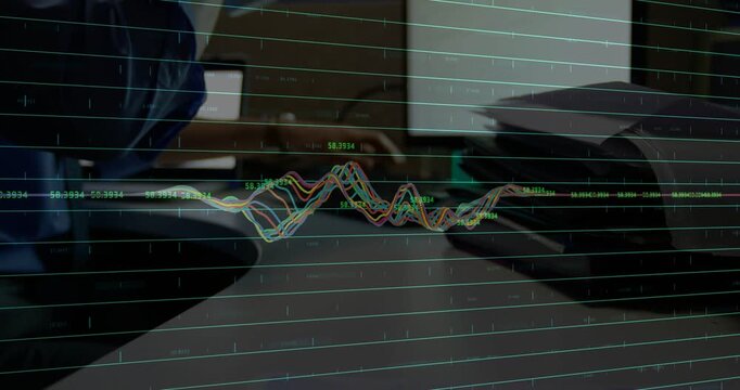 Man at desk bringing phone and reaching papers, waveform visualizing tech sensor data