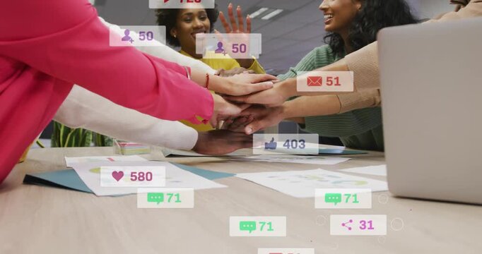 Marketers reviewing data leaning and stacking hands on table, sparking social icons boosting reach