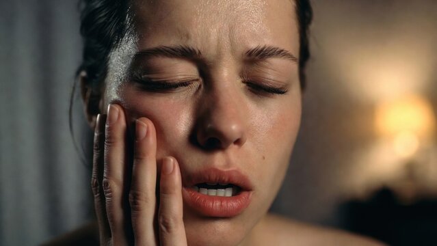 The Weight of Sorrow: A portrait capturing the raw emotion of a woman lost in thought, her face etched with a palpable sense of grief and despair.