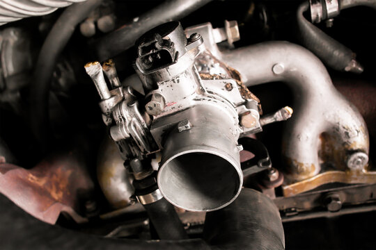 Car Engine Throttle Body, A detailed close-up of an aluminum throttle body assembly, a vital fuel system component that regulates air intake for internal combustion.