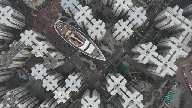 Overhead drone flight over peculiar cruise ship shaped commercial shopping mall in residential neighborhood of Hong Kong