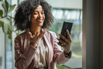 African american businesswoman communicating during a video call on phone