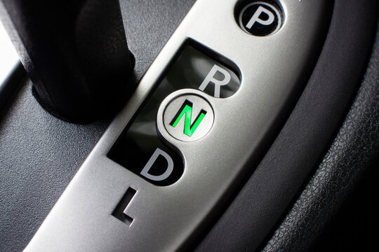 Automatic Gear Shifter, A close-up of a modern silver automatic transmission gear shifter showing P, R, N, D, and L, with the neutral N position illuminated green.
