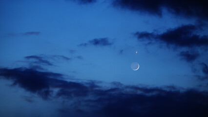 Fototapeta premium Blue hour time with crescent Moon, stars and planets.