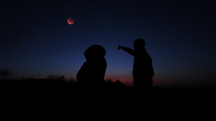 Fototapeta premium Amateur astronomers enjoying night sky with stars, planets, Moon eclipse and other celestial objects.