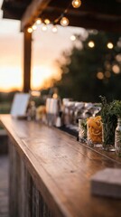 A charming outdoor wooden bar counter at sunset is adorned with cheerful string lights, creating a warm and inviting atmosphere amidst blurred natural greenery.