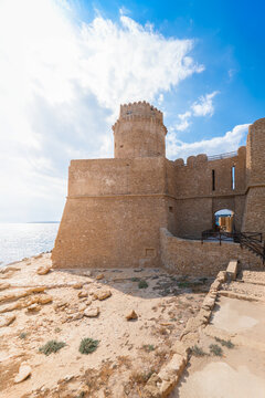 View of the historic Aragonese Castle with its round stone tower and fortified walls overlooking the Ionian Sea in Crotone, Cala