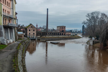 Fototapeta premium Weir on Labe river and an old factory in Jaromer, Czechia