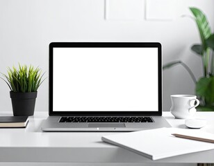 Fototapeta premium A clean and minimalist desk setup with a laptop, plant, and coffee cup.