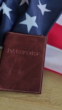 Passport and American flag on a table with a simple background showing travel and identity themes in a compact view
