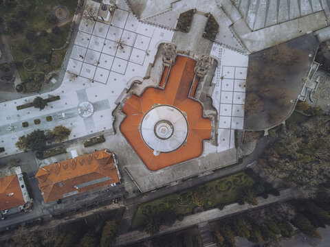 Aerial view of the Santuario de Nossa Senhora do Sameiro's orange roofs contrast with the gray stone and geometric patterns below, Braga, Braga, Portugal.