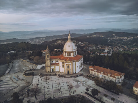 Aerial view of the majestic Santuario do Sameiro basking in the soft light, its white dome a beacon against the backdrop of rolling hills, Braga, Braga, Portugal.