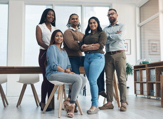 Fototapeta premium Leader, woman and team with portrait at agency for journalism, creative experience or about us. Editor, journalists and smile with arms crossed in office for news reporting, copywriting and diversity