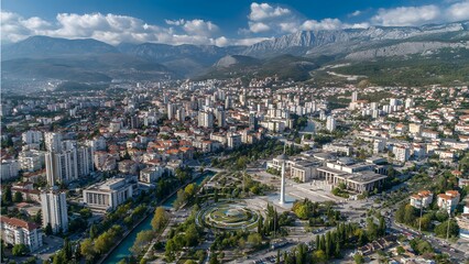 Obraz premium Aerial View of Modern City Center with Circular Park and Mountain Range