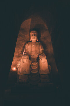 Serene Buddha statue illuminated in warm light at Leshan's Eastern Buddha Capital, China &mdash; spiritual, cultural, and architectural landmark.