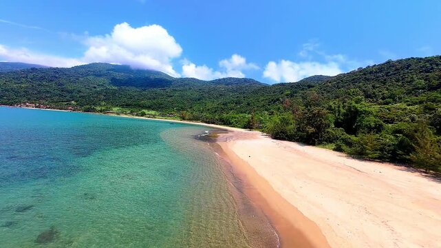 Cinematic FPV drone flight over Son Tra Peninsula in Da Nang, Vietnam, featuring tropical beaches, coastline and dramatic clouds from an immersive aerial perspective.