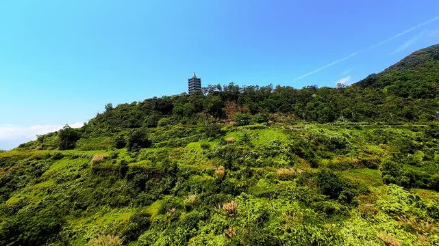 Cinematic FPV drone flight over Son Tra Peninsula in Da Nang, Vietnam, featuring tropical beaches, coastline and dramatic clouds from an immersive aerial perspective.