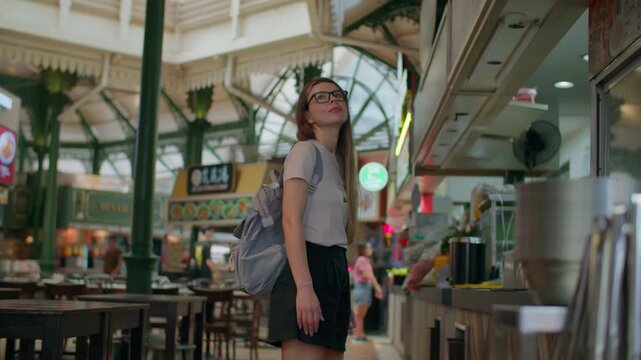 Female tourist choosing food at Lau Pa Sat food court in Singapore, authentic hawker street cuisine and Asian travel experience
