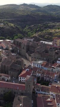Mirabel Palace in Plasencia during sunset, overlooking the historic rooftops and cityscape. Vertical Aerial