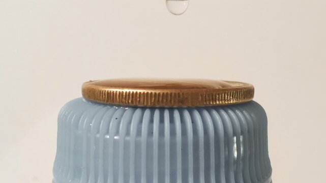 Water surface tension on a coin.