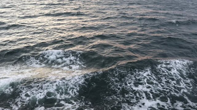 Sea waves moving on the side of the boat, top down b roll