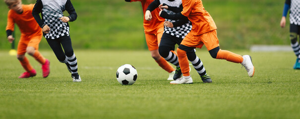 Youth Soccer Match Action – Kids Competing for Ball During Outdoor Football Game © matimix