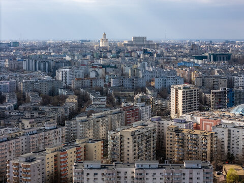 Aerial view of the sprawling cityscape, where dense buildings meet the sky, revealing the iconic Palace of the Parliament, Bucharest, Bucharest, Romania.