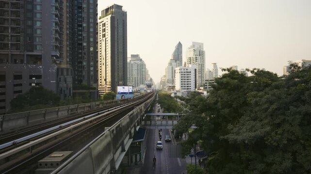 Bangkok skytrain railway and urban cityscape with traffic and modern skyscrapers in Asian Capital city during daytime