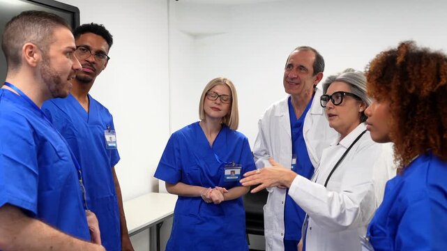 Group of diverse doctors and nurses in scrubs and lab coats actively discussing and collaborating during a staff meeting in a modern hospital, sharing professional knowledge and expertise
