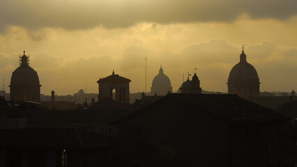 Obraz premium Rome historical center old skyline with iconic St Peter dome silhouette with afternoon yellow sky