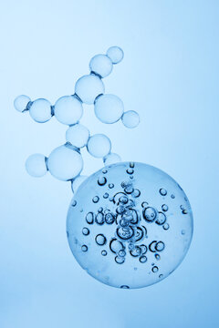 Abstract cosmetic lab. Blue molecule structure and bubbles in clear liquid