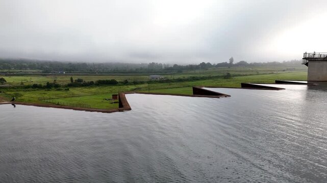 Telephoto aerial view over Midmar dam radial gates to manage capacity, Howick