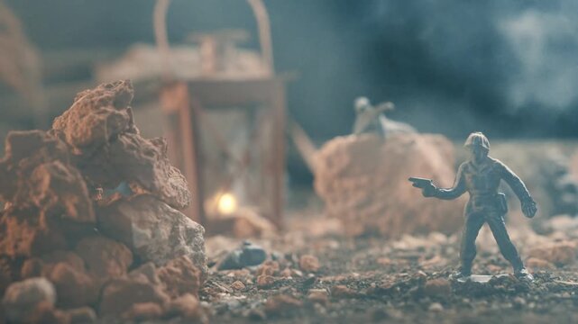Miniature plastic toy soldiers creating a war battle scene. A dramatic diorama of a conflict zone with smoke, rocks, and a lantern