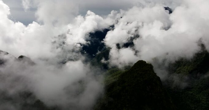 Mysterious white mountain fog around Andes Mountains near Machu Picchu, aerial