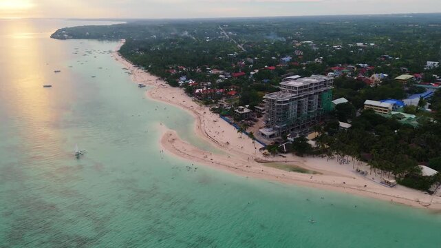 Aerial drone view at sunset of the pristine white sand beaches and emerald waters of Bantayan Island, Cebu, Philippines travel destination