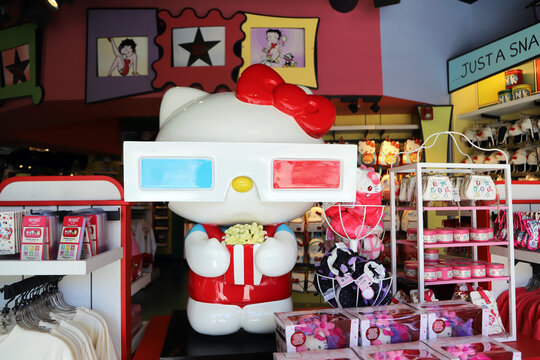 Giant Hello Kitty figure in a themed shop. Kawaii merchandise and colorful decorations