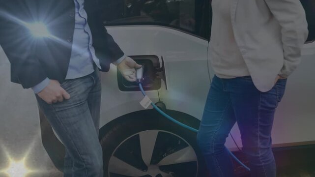 Animation of light beams moving over caucasian couple at electric vehicle charging station