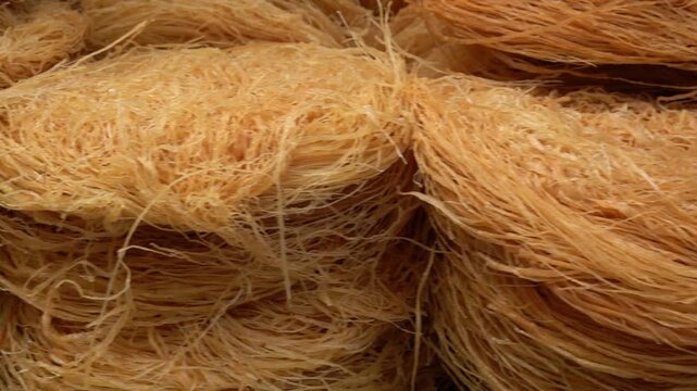 Close-up of traditional raw kataifi shredded phyllo dough, a versatile middle eastern and mediterranean pastry ingredient for baklava and other sweet desserts