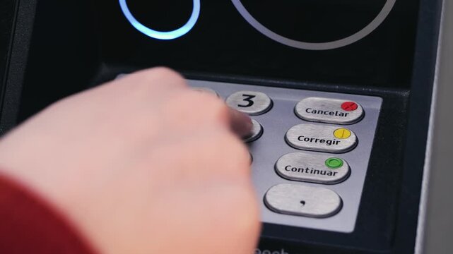 Close-up of hand entering PIN code on ATM keypad. Banking, finance, security and transaction concept. High quality 4k footage
