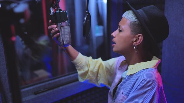 Woman singer recording new music album inside boutique studio - Technology and record label industry concept
