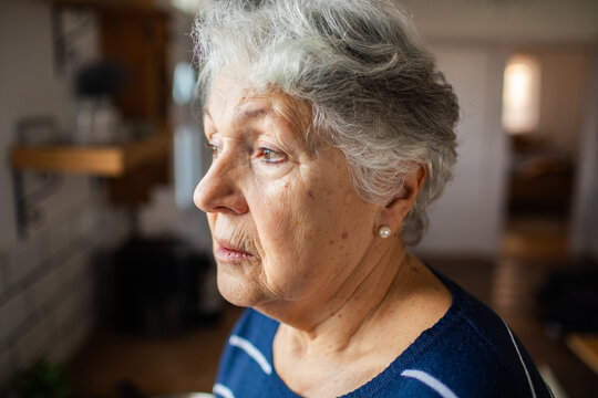 Pensive senior woman in home kitchen
