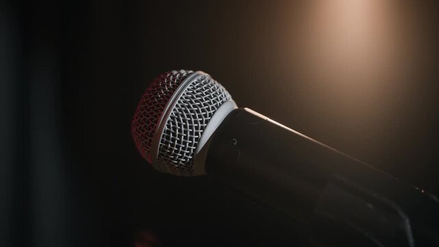 Close up of microphone standing on stage of comedy bar in backlight awaiting performance, copy space